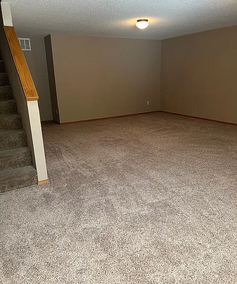 Large family room in basement with daylight windows