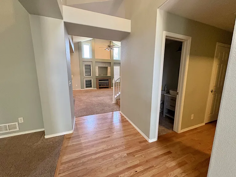 Downstairs half bath. Walkway to the right to master suite. Walkway through to living room and kitchen