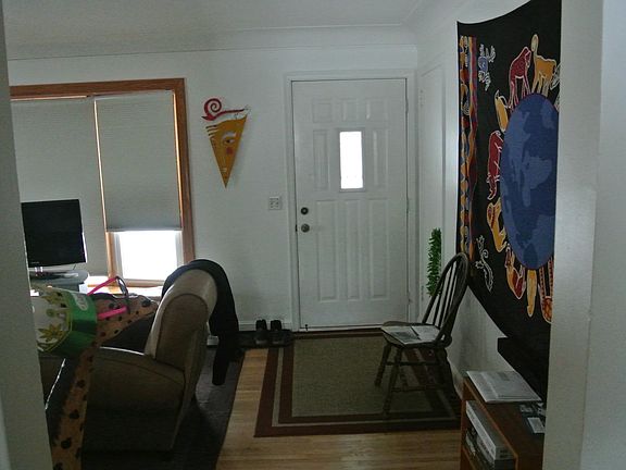 Living room from the hallway, facing the front door.