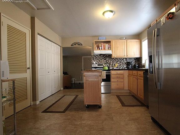 Another view of the kitchen. Full laundry behind the white folding doors.
