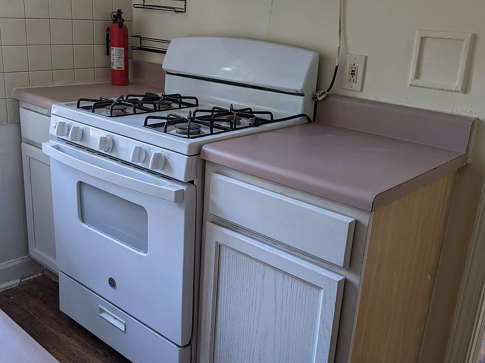 Kitchen with gas oven, range vent, additional food preparation area and storage cabinets
