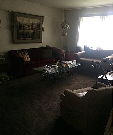 Living room with new paint and beautiful dark brown carpet.