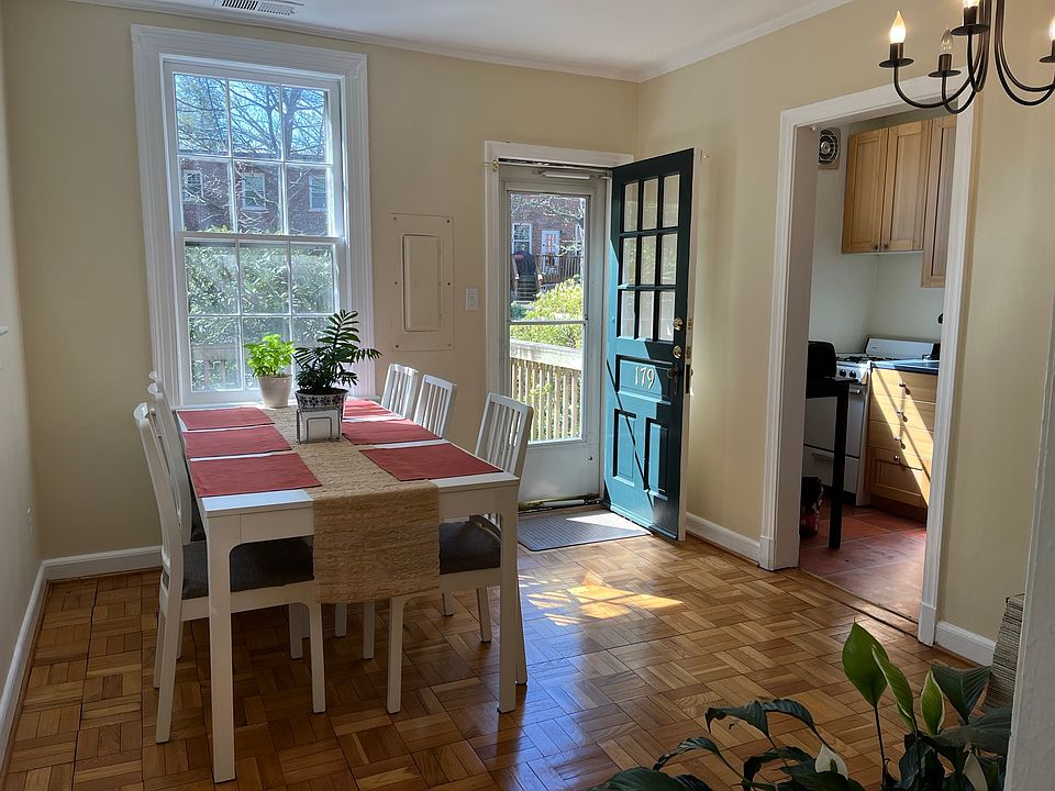 Dining room has hardwood floor and chandelier. Access private deck from here.