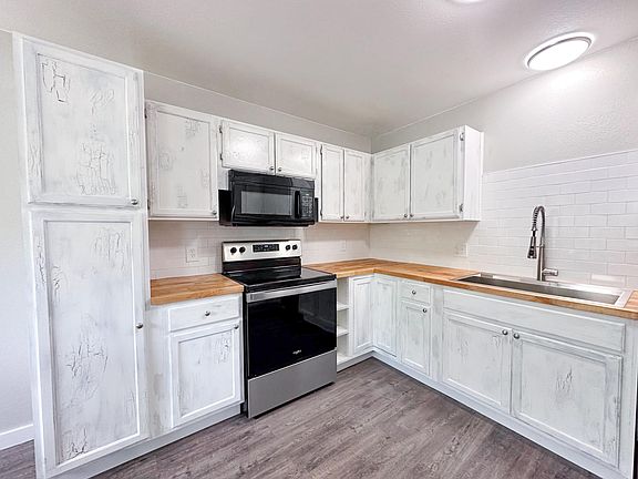 The kitchen has a new stove, garbage disposal, and dishwasher.