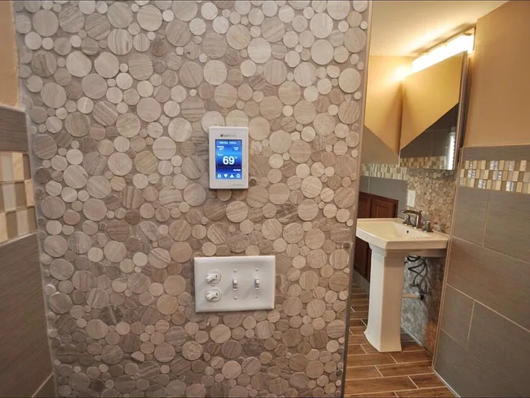 Marble, Granite, and porcelain Tile bathroom with heated floors and spa-quality fixtures and tile-work.