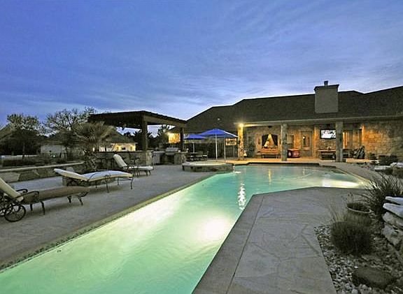 back of house with pool that as a lap lane