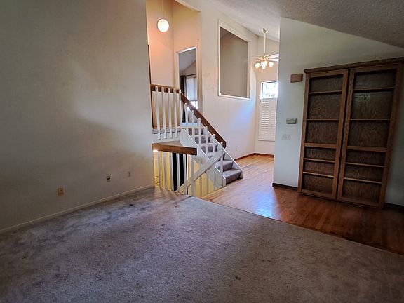 Front door, bookshelf coat closet, upstairs multipurpose room