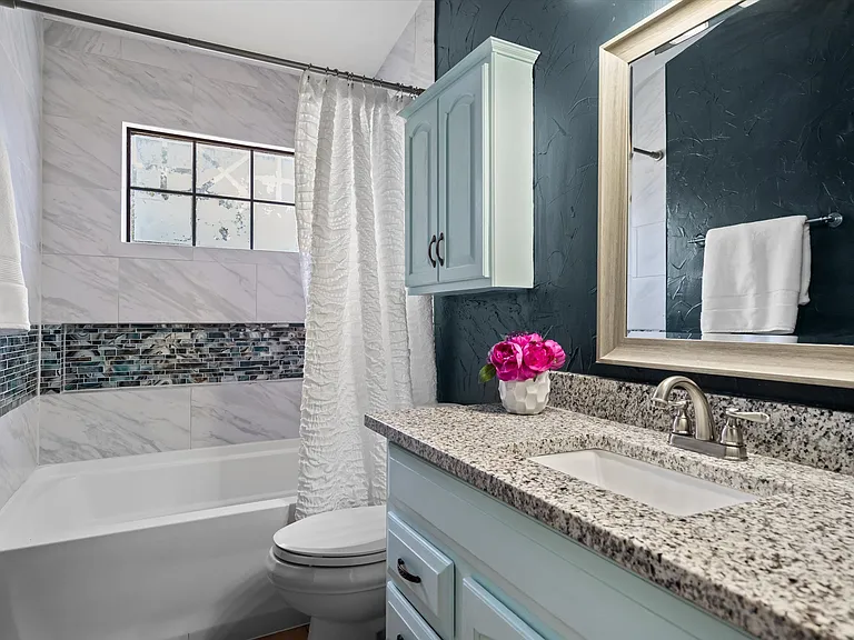 The updated primary bath has more striking tile accents!