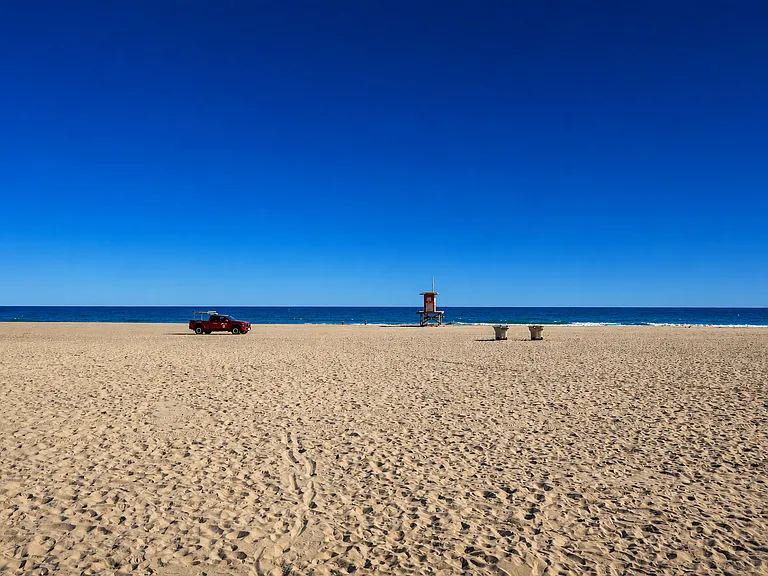 Open sandy beach with lifeguard tower views