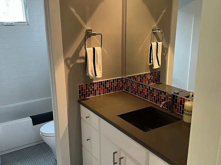 Upstairs hall bathroom. Toilet and shower/tub room is private. Pocket door in shown room hides washer/dryer.