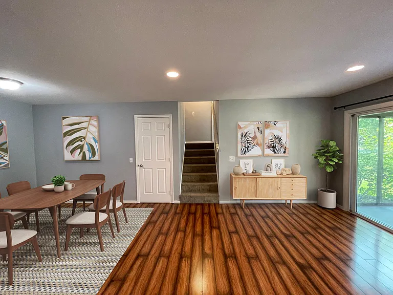 Closer view of the staircase leading downstairs (behind door) and upstairs.