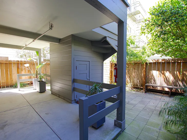 Private covered deck opens into shared outdoor space