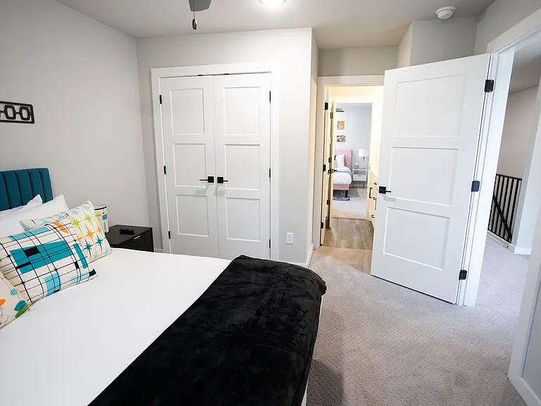 Third bedroom (upstairs) has a queen bed and a TV. It shares a jack and jill bathroom with bedroom 2