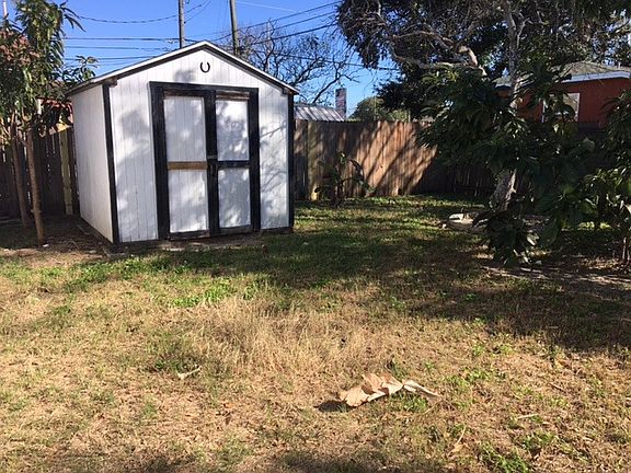 Fenced back yard with shed