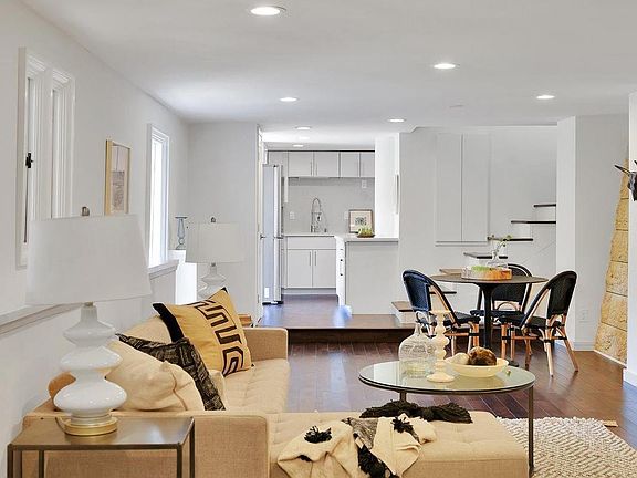 Stairs leading to a small changing space, bathroom and closet with mirror door