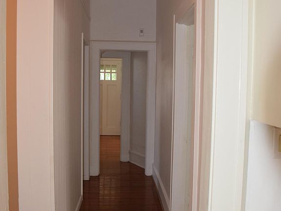 From the kitchen. The bathroom is to the immediate left of the hall and doorway. Large closet for linens, products, etc. outside the bathroom. End of the hall you see front door, nice foyer area with closet, living room to right.