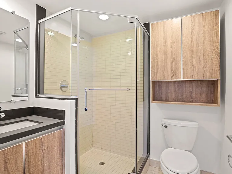 Bathroom with Stand-Up Shower with Glass Door and Cabinet Storage