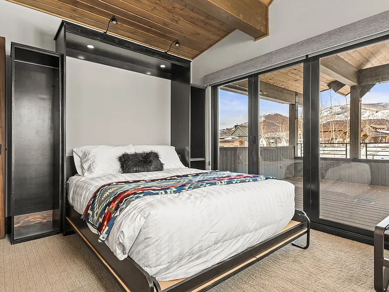 Upper Level Ensuite Bedroom 4 _ Currently set up as an office with a Queen Murphy Bed & Private Deck