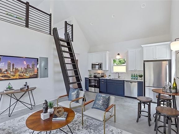 alt. view of living area and ladder to loft relative to kitchen