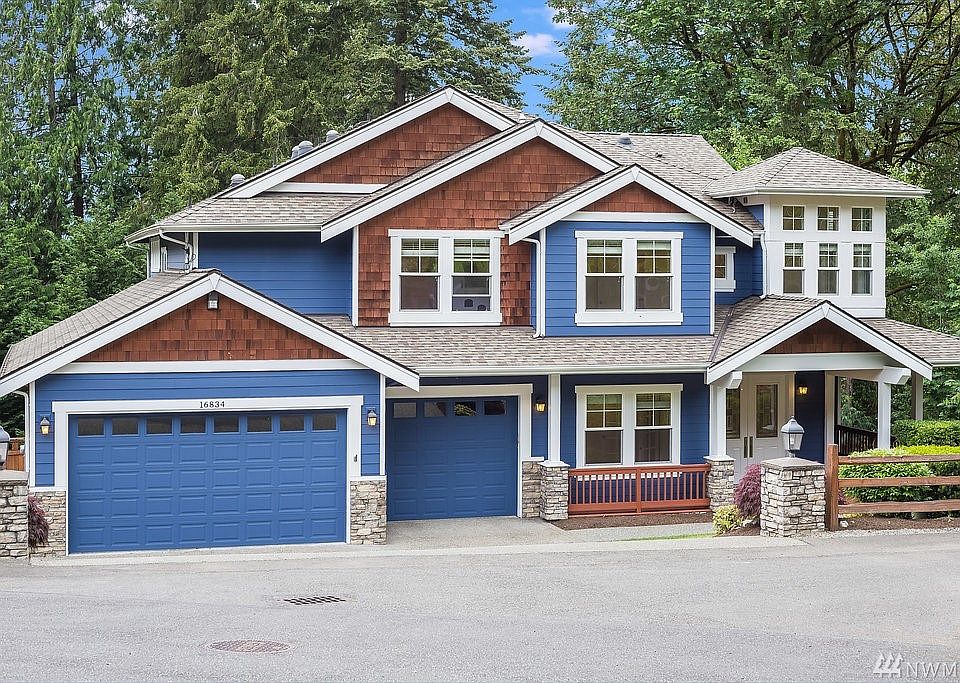 Spacious 3 car garage w room enough for 4 cars and additional work shop area.