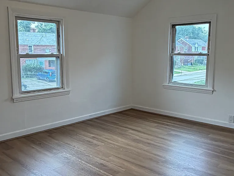 One of the bedrooms - new flooring , paint and ceiling fan