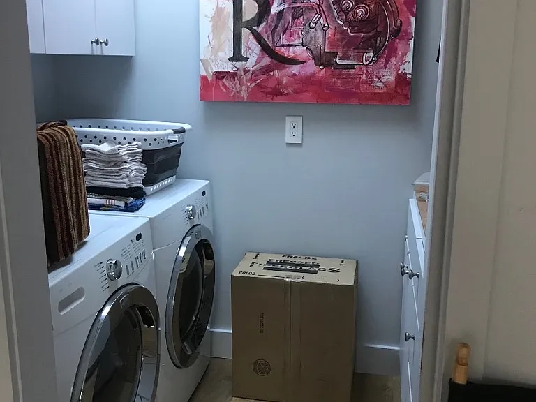 Full size washer and dryer off kitchen