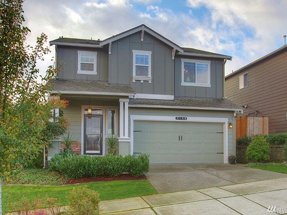 Charming front porch and nicely landscaped.