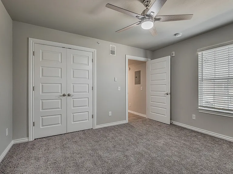 Experience comfort in this spacious and light-filled bedroom.