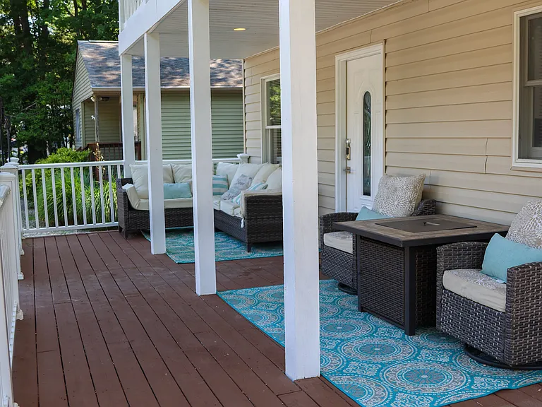 Partially covered wrap around front porch with keyless entry.
