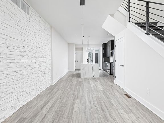Dining room with stone wall and pendant light