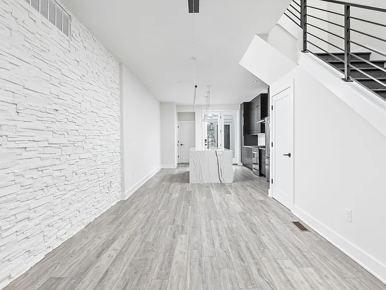 Dining room with stone wall and pendant light