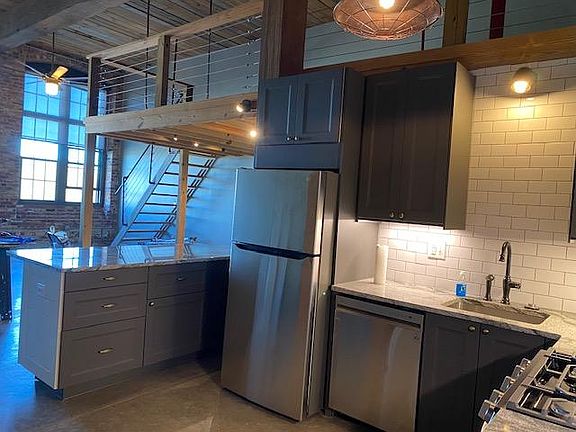 Kitchen with Stairs to loft in background