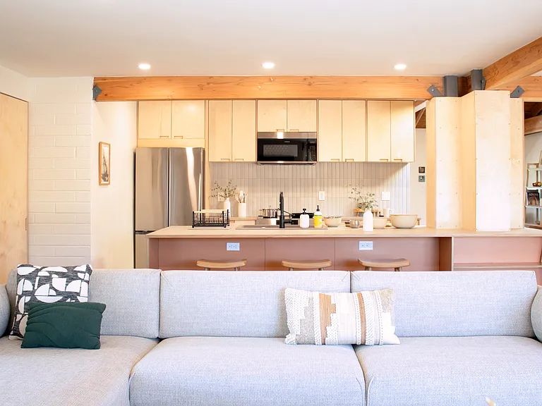 Open-concept living and kitchen with large island and seating.