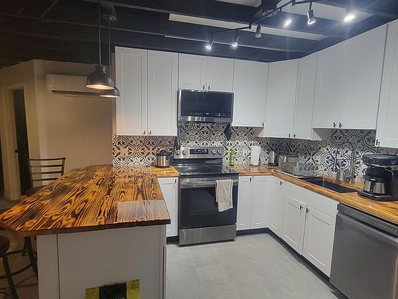 Kitchen includes large breakfast bar with seating for 3.