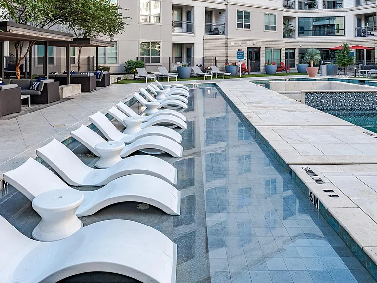 Stylish Poolside Sundeck Featuring Lounge Chairs and Community Seating