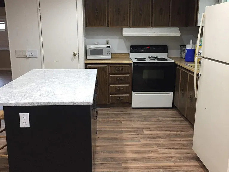 Kitchen with new island and closet pantry.