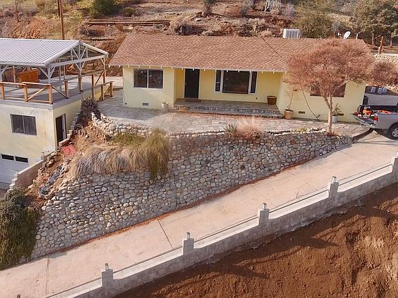 Garage, studio, covered deck on left, main house on right