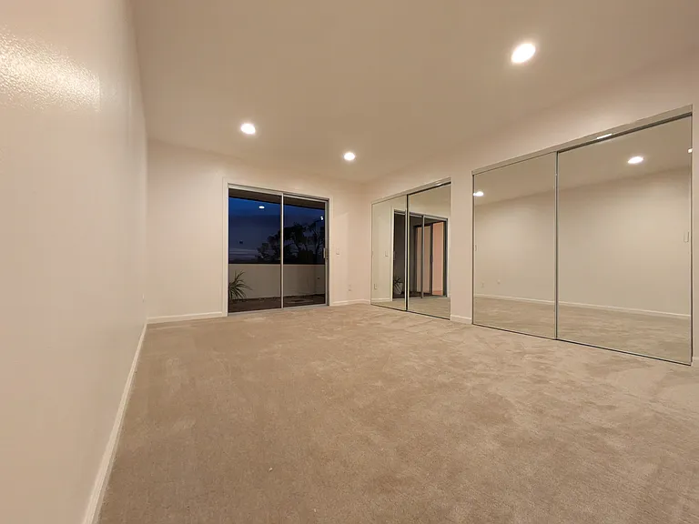 Primary Bedroom with Huge Closets and Sliding Door to Balcony