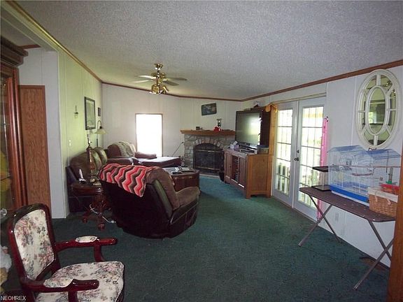 Living room with French doors...carpet is being replaced with wood laminate flooring