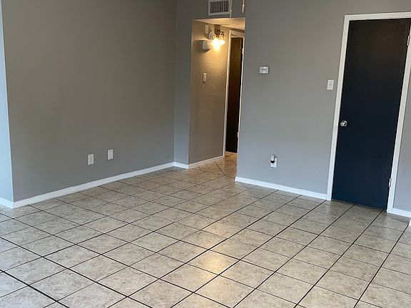 Living room features nice-sized storage closet and ceiling fan.