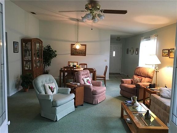 View of Living / Dining room (Great room) showing vaulted ceiling, ceiling lights & fan