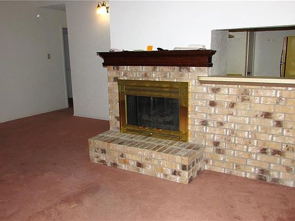 Large den with vaulted ceiling, wood burning FP and pass through to kitchen