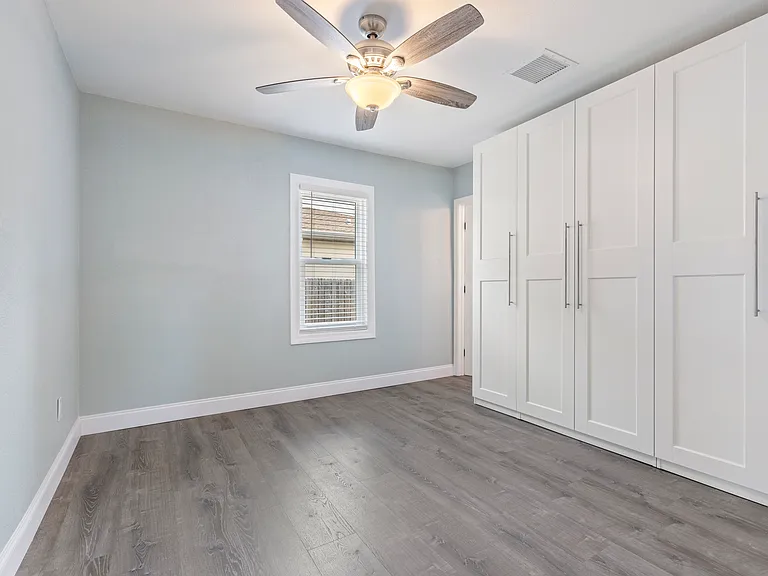 Unwind in this serene master bedroom featuring built-in closets for streamlined storage, fresh paint, and luxury vinyl flooring that ties together comfort and modern design.