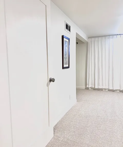 Bright and spacious room A, 180 sqft. with 2 wall art and a big closet. Window facing west street.