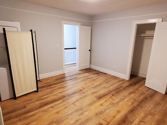 The bedroom. On the left is the over/under washer/dryer.