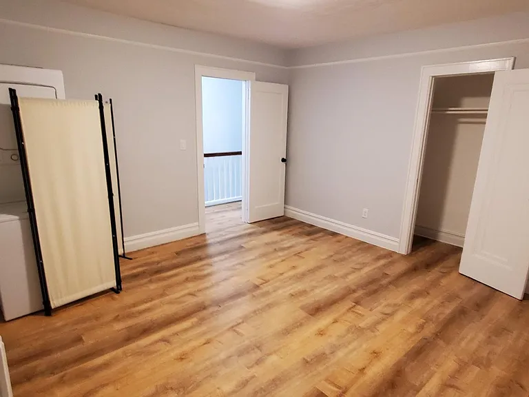 The bedroom. On the left is the over/under washer/dryer.