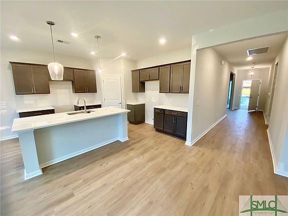 Large Island With With Quartz Counter Tops in Kitchen