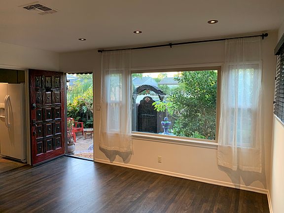 View from the inside of the spacious living room looking out through the light giving window into the private zen-garden