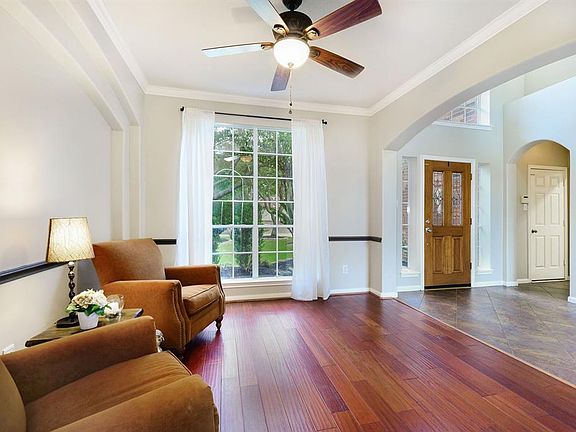 Just off the entry, is the formal dining room, currently being used as a seating area! Gorgeous picture windows, crown molding and double niches creates an inviting space for all to enjoy!