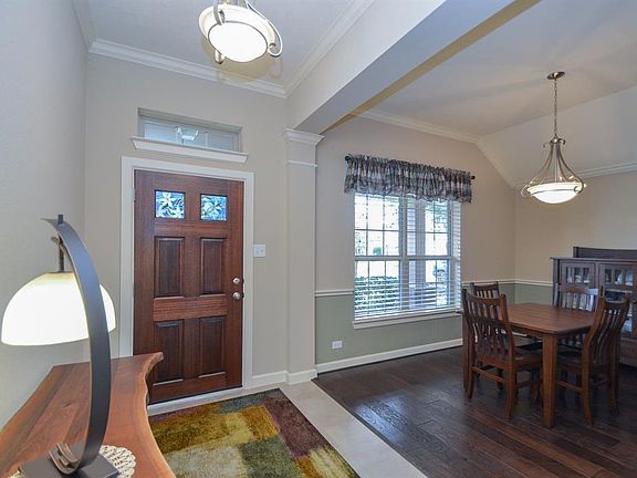 Bright and spacious foyer with crown molding and tile floors. The crown molding adds a hint of elegance that burst through the dining room.